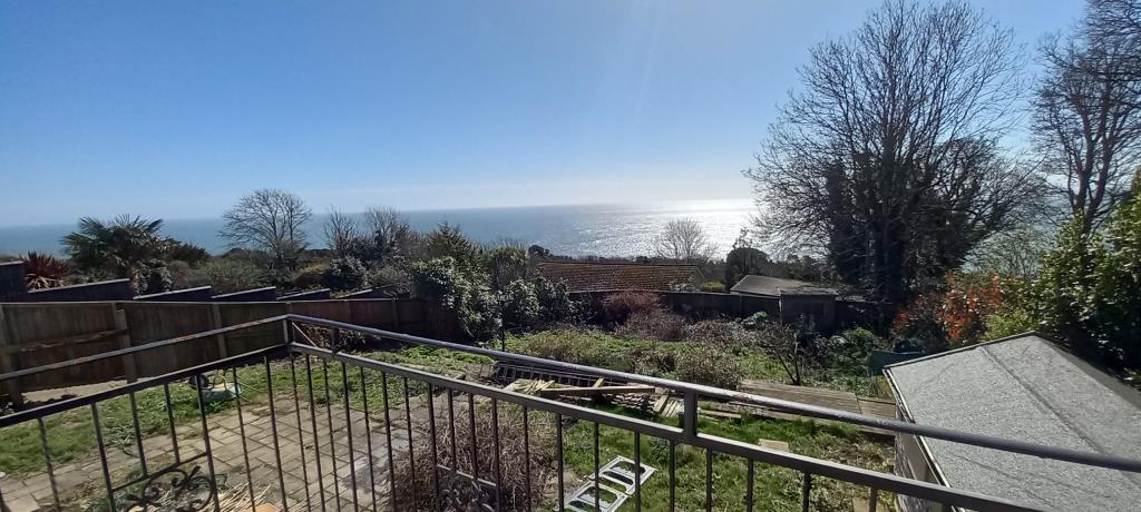 Lot: 99 - HOUSE WITH SEA VIEWS WITH CONSENT FOR DEMOLITION AND CONSTRUCTION OF SIX TWO-BEDROOM APARTMENTS - Sea views from balcony photo of bungalow in Ventnor Isle of Wight